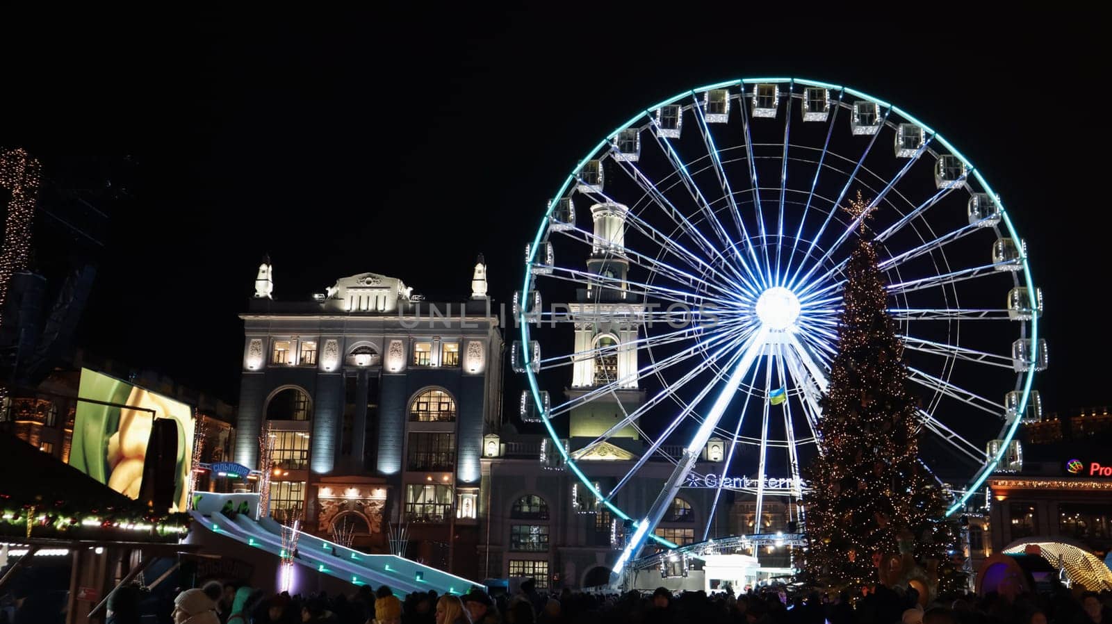 Ukraine, Kiev - January 15, 2019. Illuminated Ferris Wheel on Kontraktova Square in Kiev in the evening