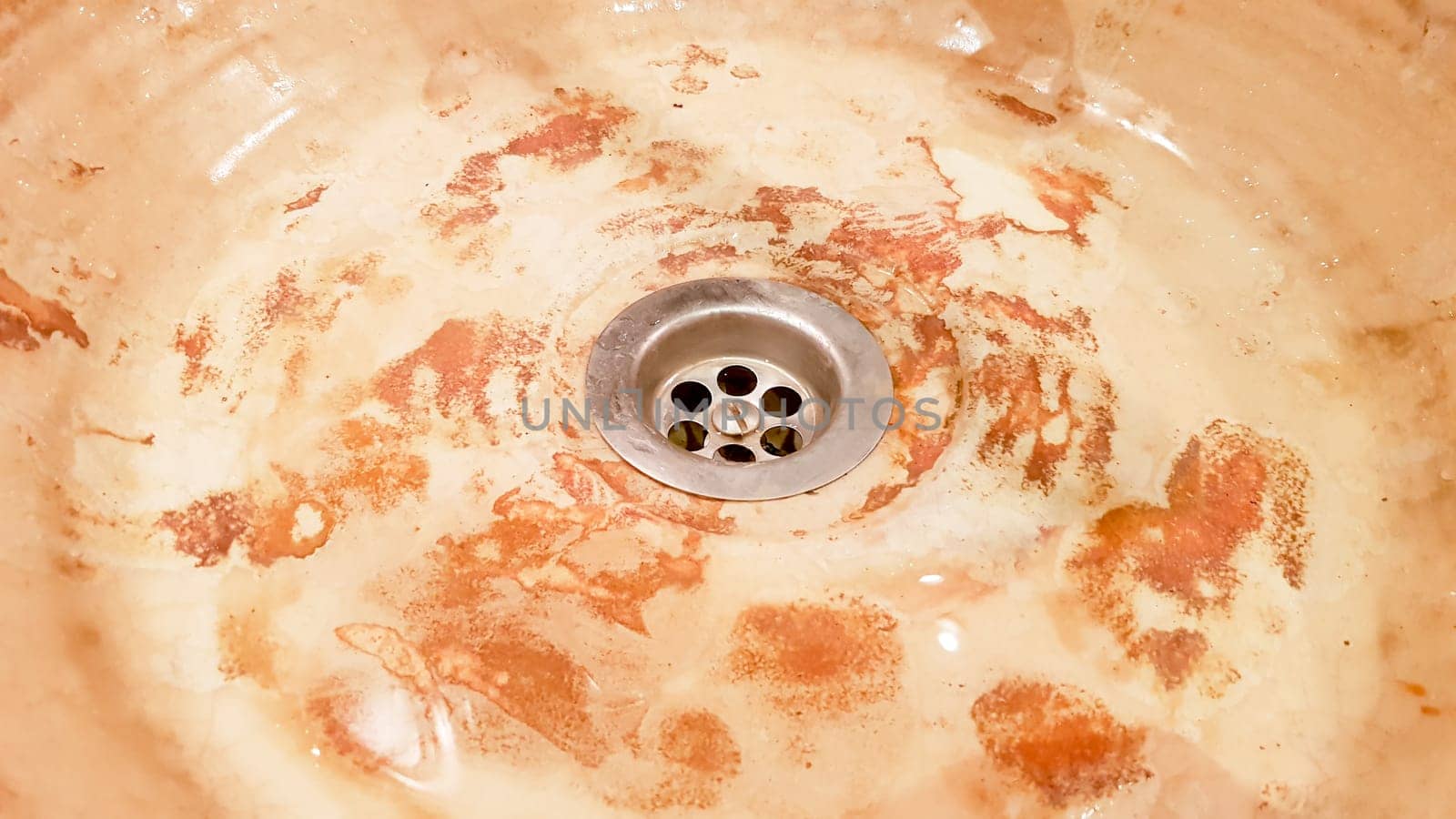 Vintage Beautiful faucet and golden mixer tap on a marble round sink in the bathroom. Interior of an expensive toilet with a marble sink.