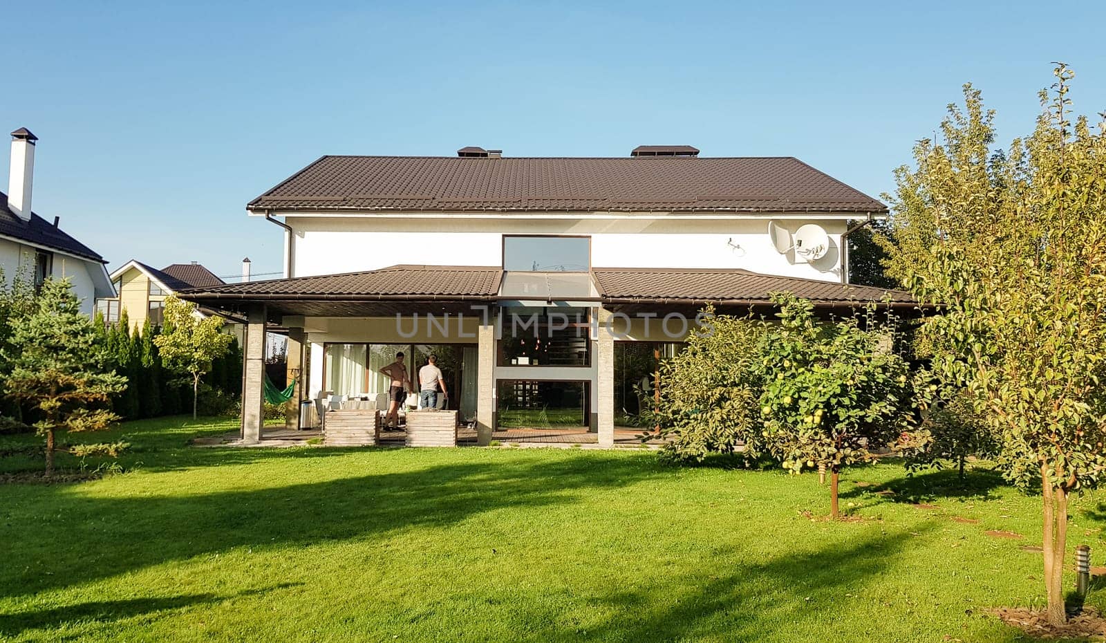 Ukraine, Kiev - September 24, 2019: Facade of a new modern house in the Australian style. Luxury Villa Resort Interior. Large luxury custom house with a beautifully maintained and landscaped front lawn in a suburb
