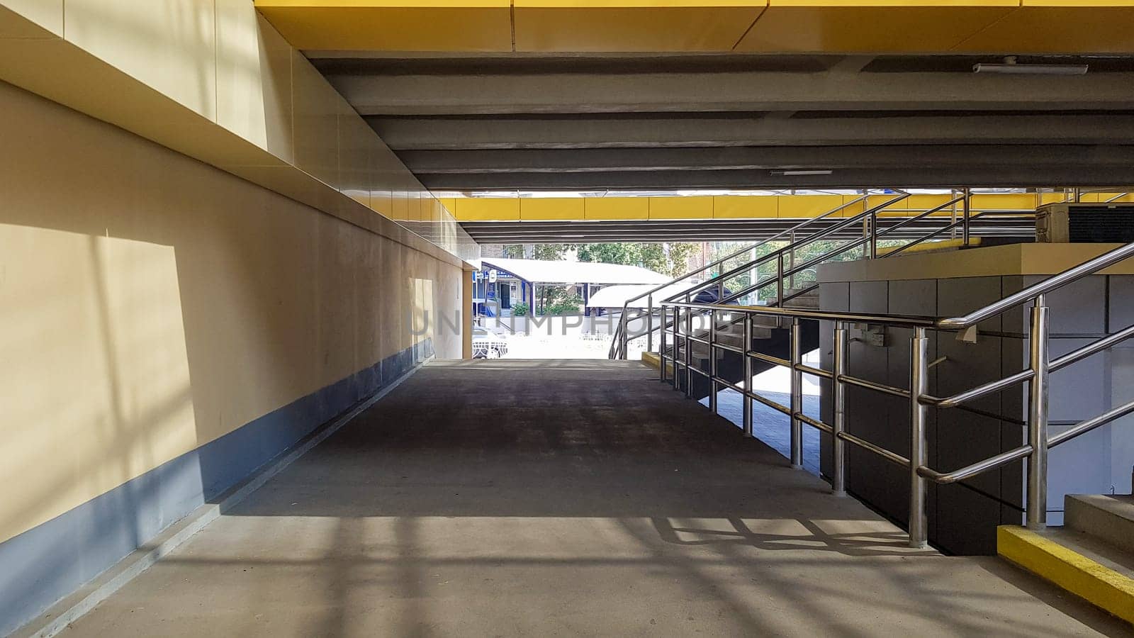 Ukraine, Kiev - September 24, 2019: light rail station. Design of a bus stop and a pedestrian underpass with steps and railings made of yellow panels and a glass roof
