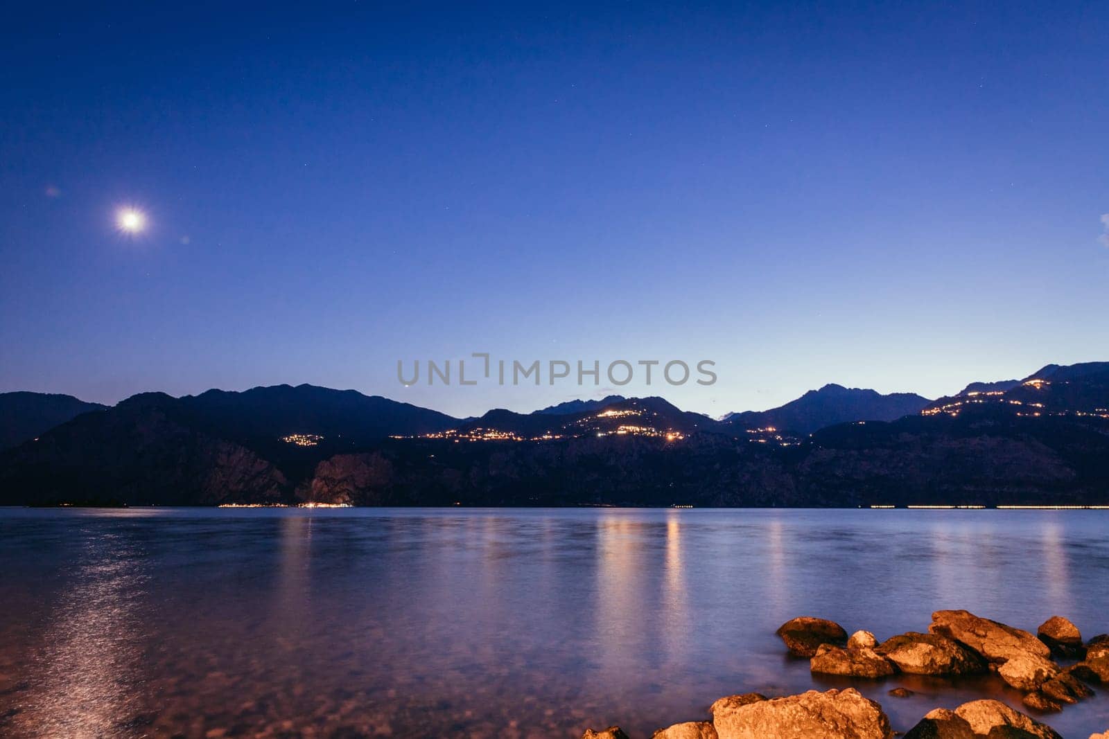 Beautiful night scenery at lago di garda. Lake, water and mountains.