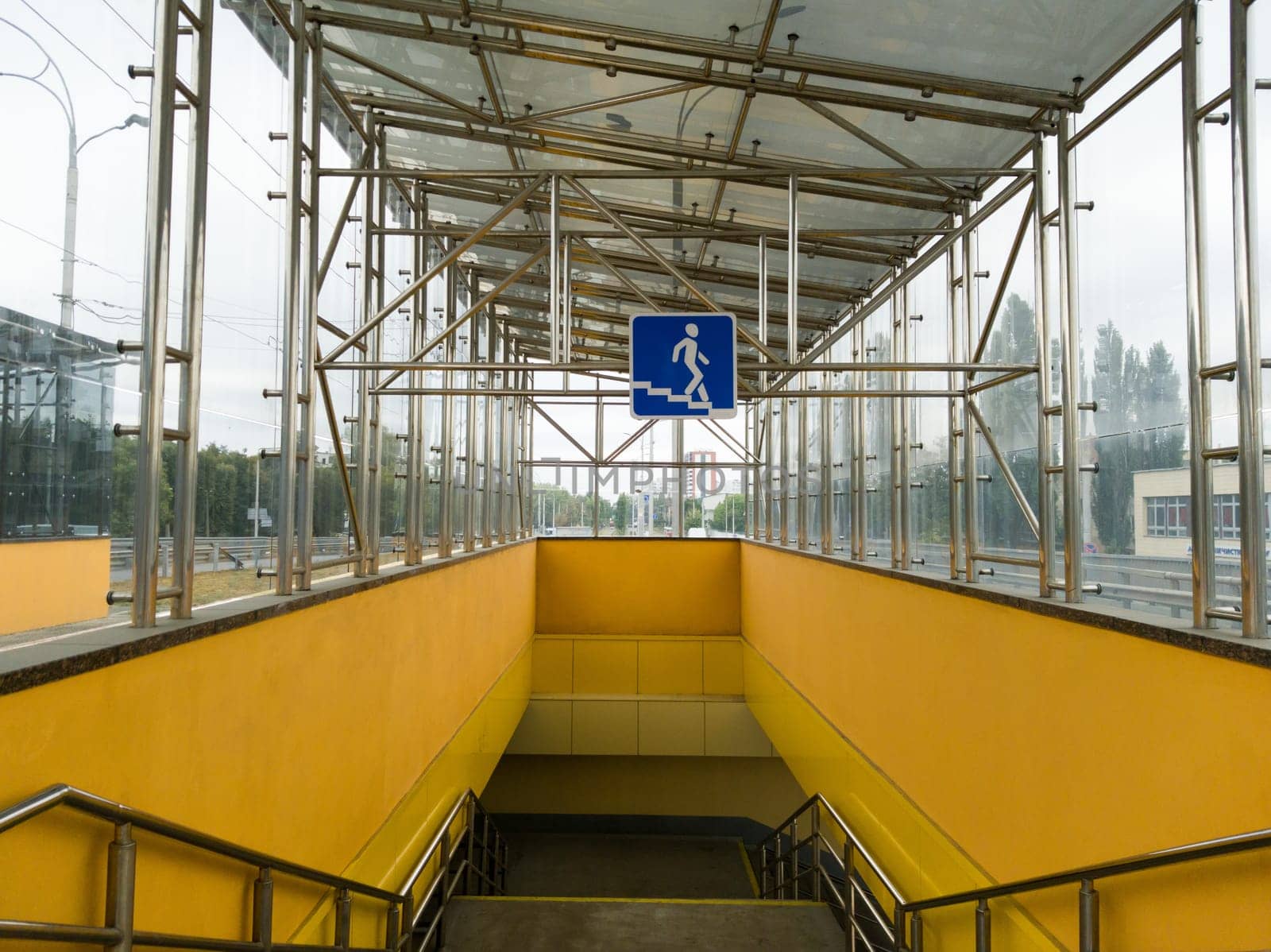Ukraine, Kiev - September 26, 2019: The sign is an underground pedestrian crossing at the entrance to the underground passage. Empty yellow underground pedestrian crossing. Blue square transition sign in the city.