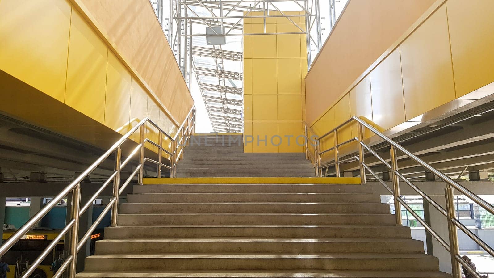 Ukraine, Kiev - September 24, 2019: light rail station. Design of a bus stop and a pedestrian underpass with steps and railings made of yellow panels and a glass roof