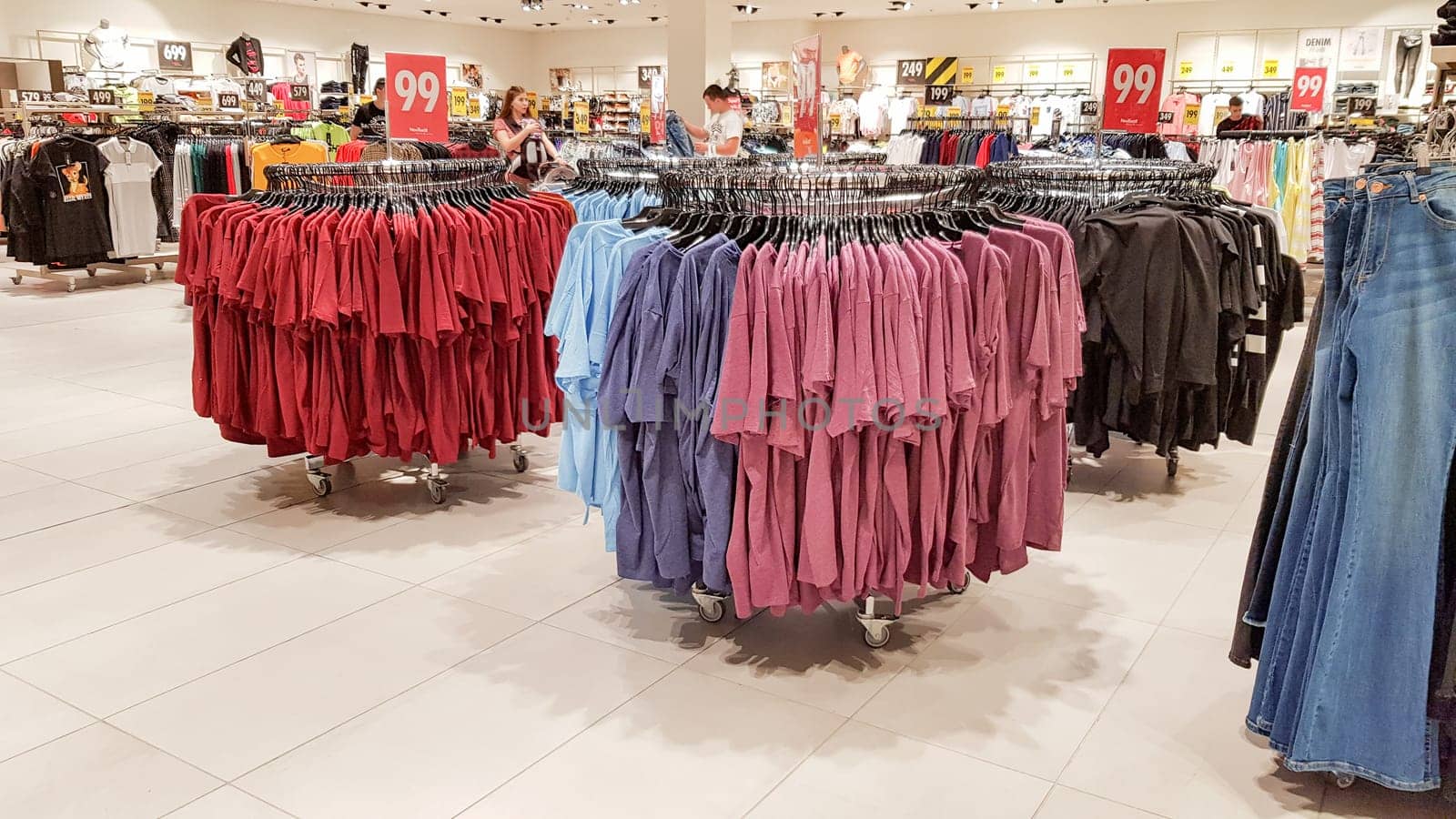 Ukraine, Kiev - September 04, 2019: A large clothing store, mannequins and many rows with hangers, a variety of sizes and colors. Black Friday, a day of shopping and sales at boutiques and malls.