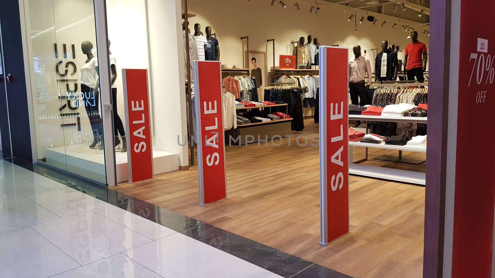 Ukraine, Kiev - September 04, 2019. Sale signs in a shop window in a shopping center on the day of shopping and the international holiday Black Friday, sale and discounts in clothing boutiques.