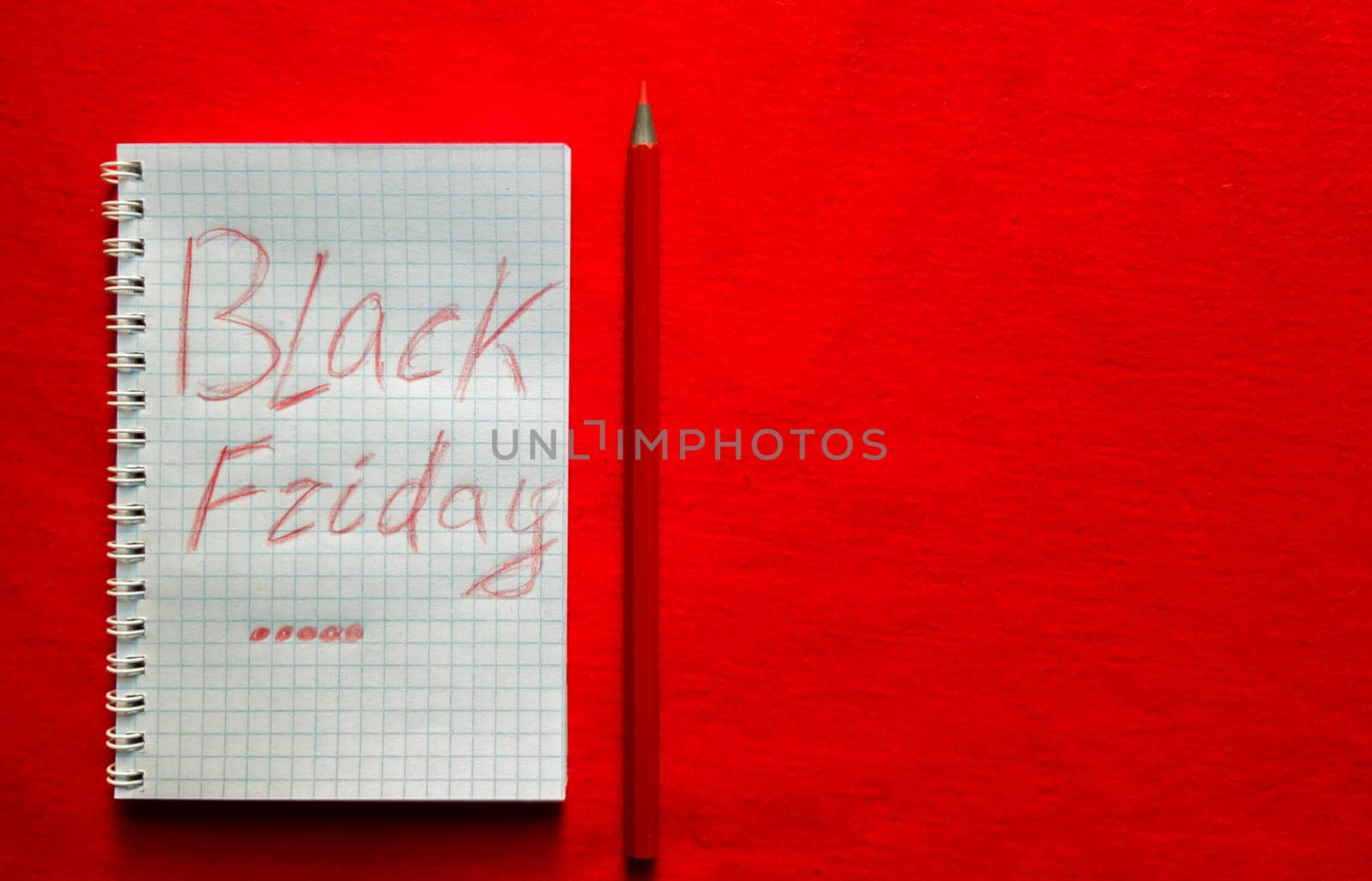 Black friday sale text written on a notepad with a red pencil on a red background. Background, holiday concept. Black Friday - International Day of Shopping, Promotions, Discounts, Sales. Sales season is the fourth Thursday of November. Copy space, place for text, flat lay.