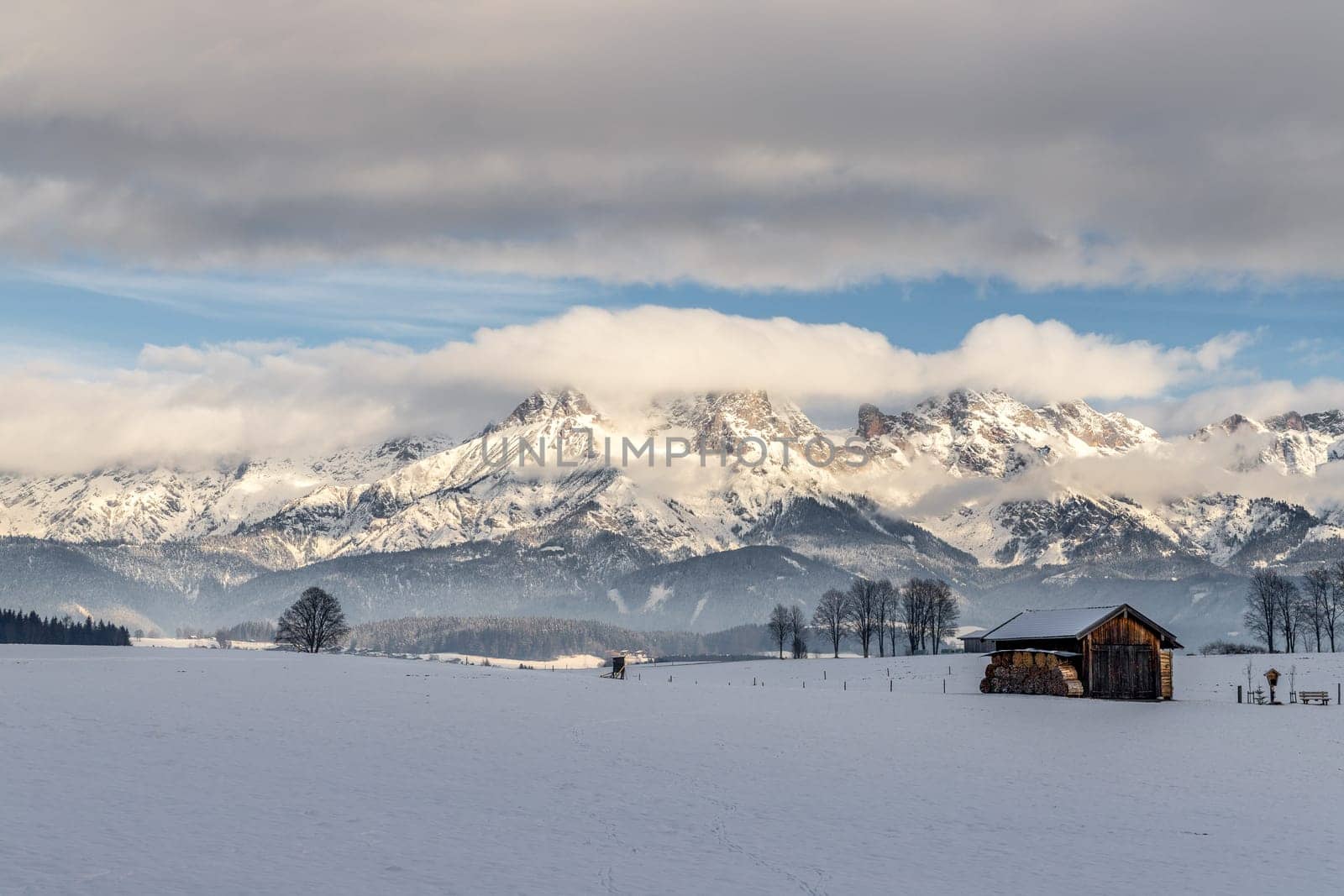 Snowy mountains, meadow and a hut, landscape in Austria