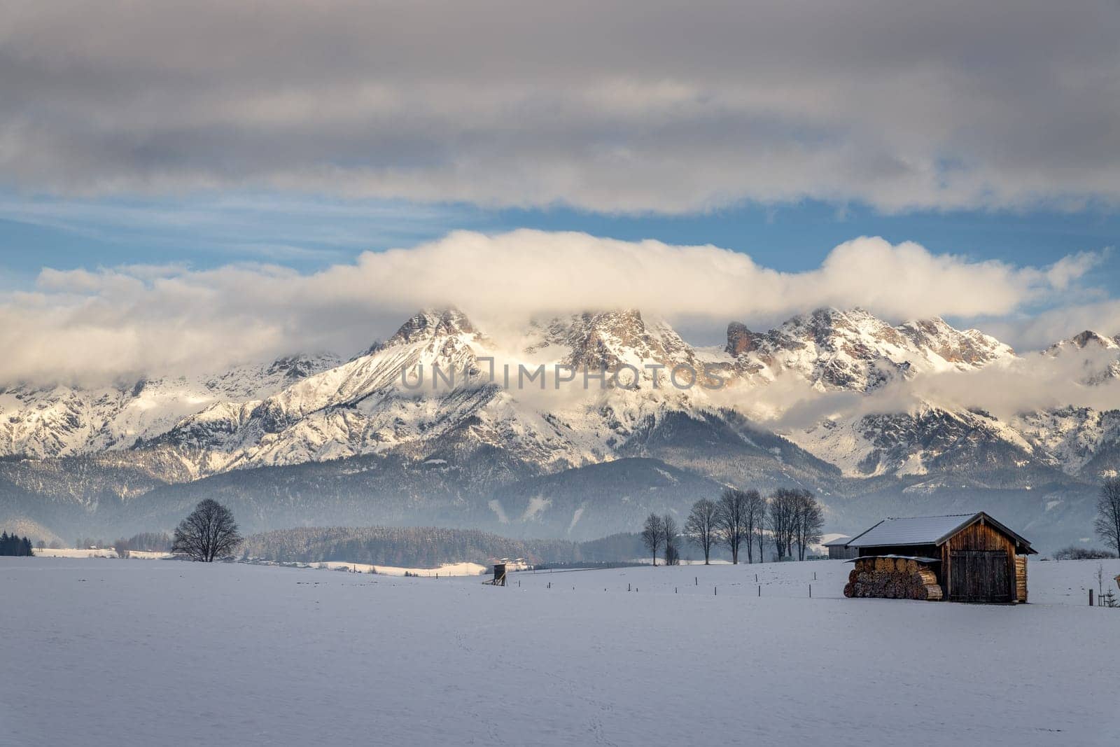 Snowy mountains, meadow and a hut, landscape in Austria