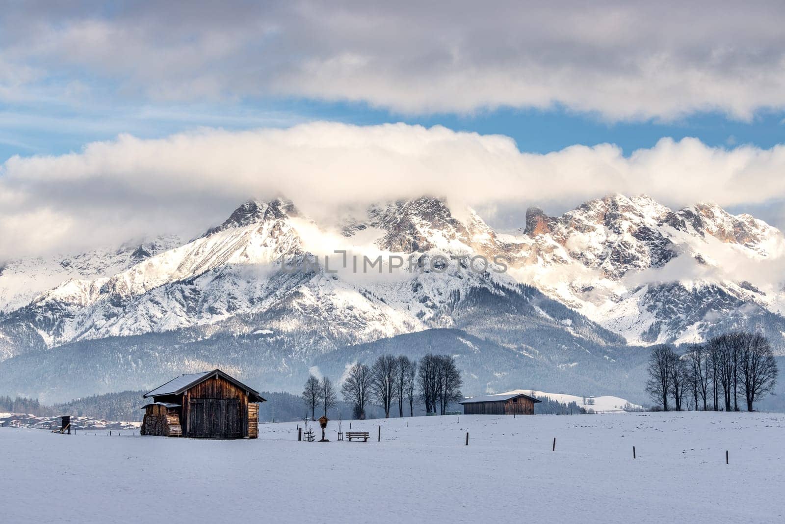 Snowy mountains, meadow and a hut, landscape in Austria