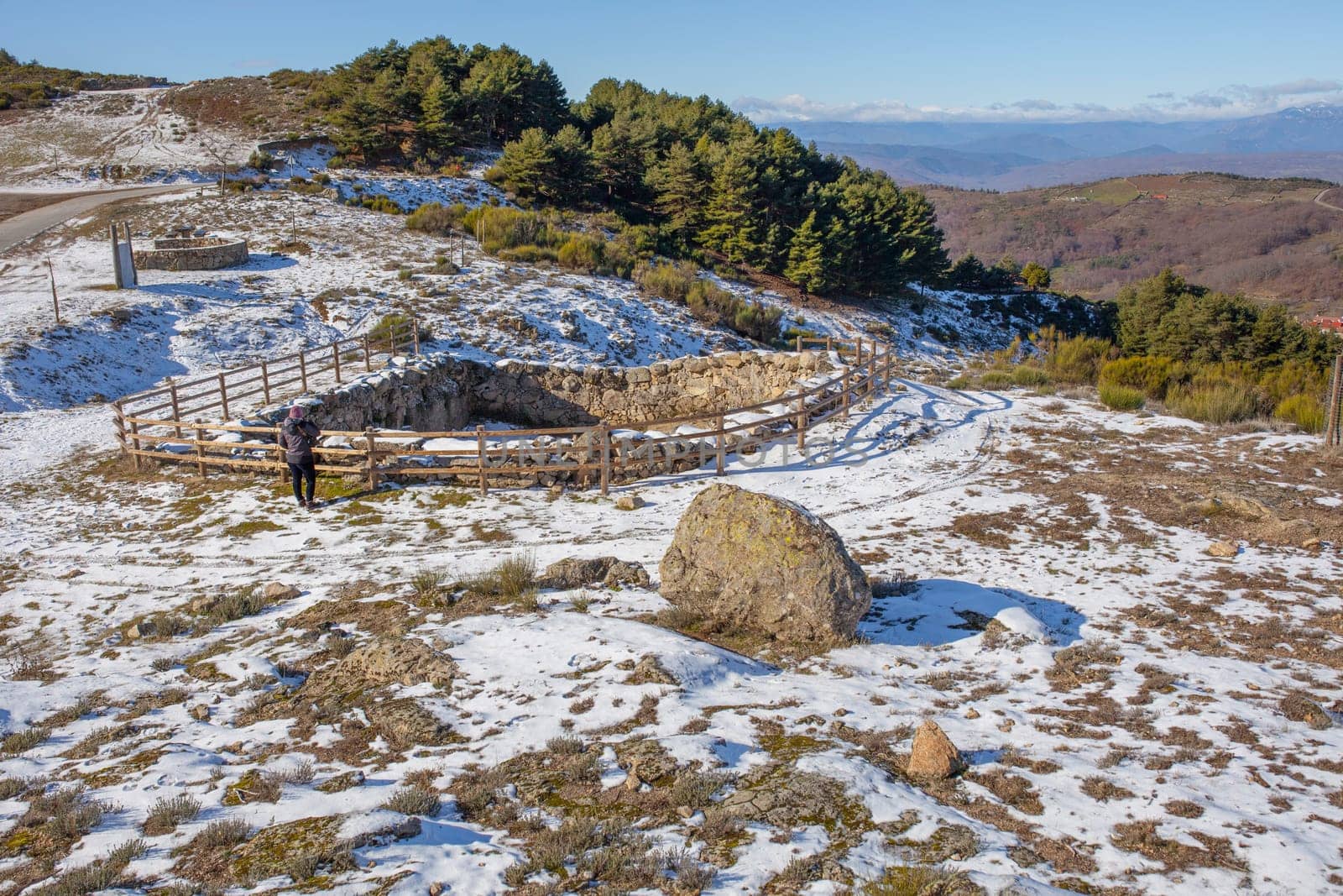 Visitor observing an old Corral de Lobos or Wolves trap. La Garganta, Extremadura, Spain