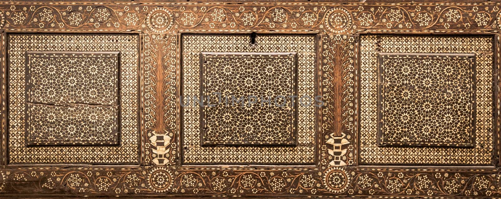 Antique art of wood decoration on a 15th century Italian furniture. Vintage and gothic background image.