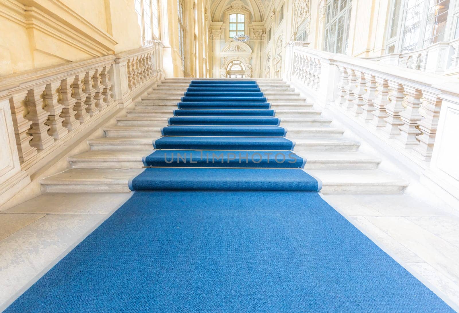 TURIN, ITALY - CIRCA JUNE 2021: The most beautiful Baroque staircase of Europe located in Madama Palace (Palazzo Madama). Interior with luxury marbles, windows and corridors.