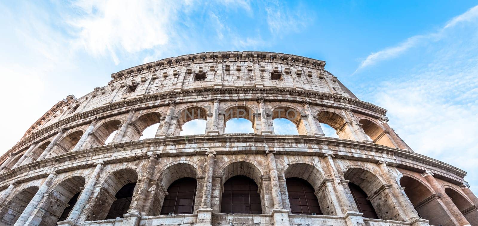 Detail of Colosseum in Rome (Roma), Italy. Also named Coliseum, this is the most famous Italian sightseeing. Spectacular blue sky in background.