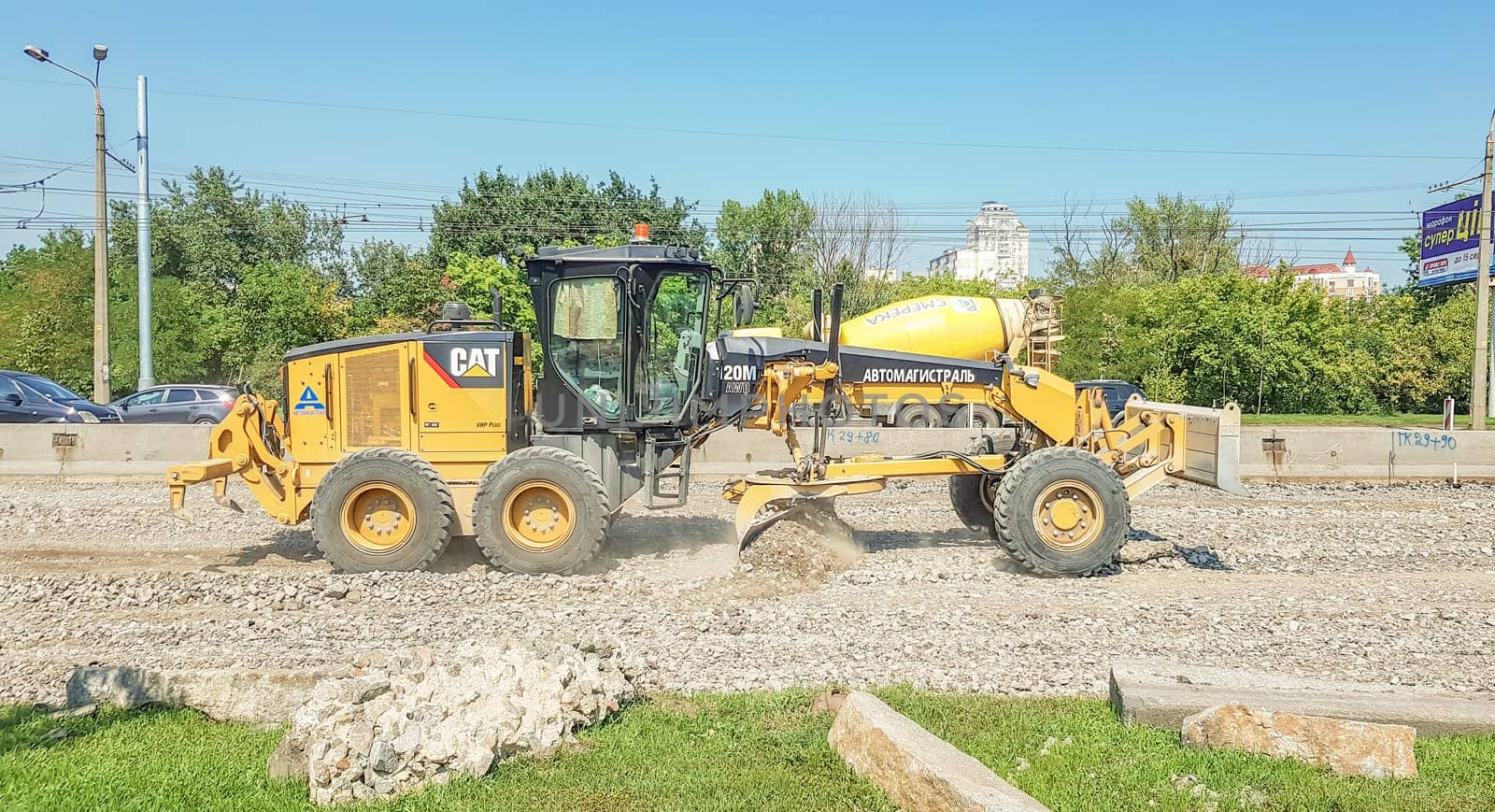 Ukraine, Kiev - October 1, 2019: Road roller, tractor and construction equipment are working on a new road construction site. The road is closed for road repair, route extension, pothole repair.