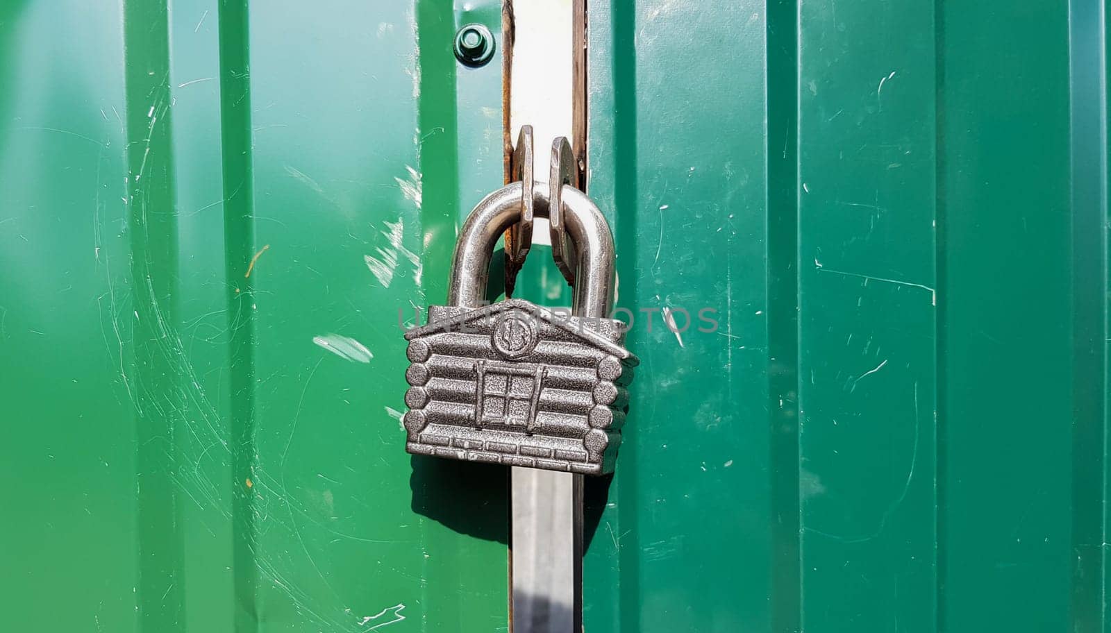 metal door with lock, texture and background. Background texture of an iron padlock on a rusty metal gate