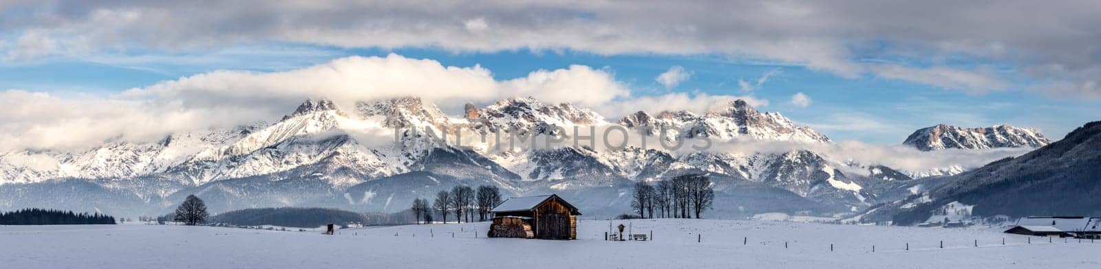 Snowy mountains, meadow and a hut, landscape in Austria, panorama