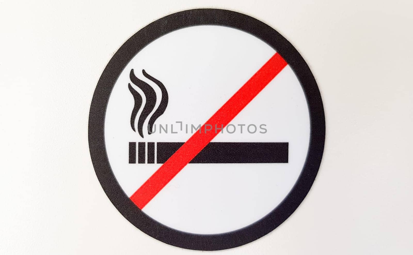 Round red and black no smoking sign, sticker in a public place on a white background.