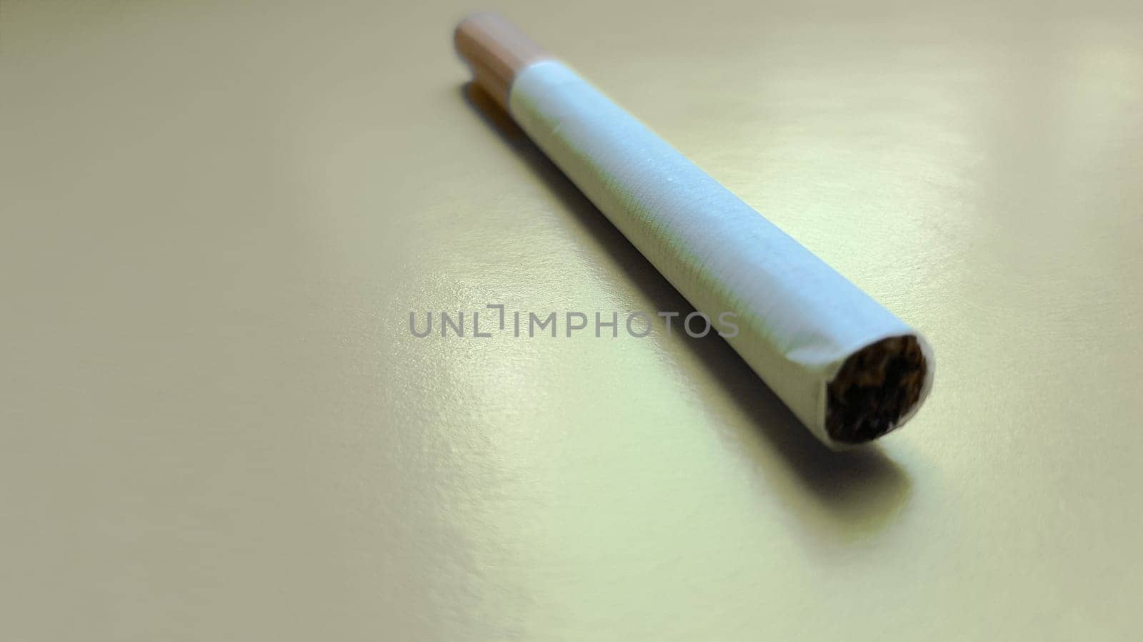Cigarettes isolated diagonal on a yellow background.