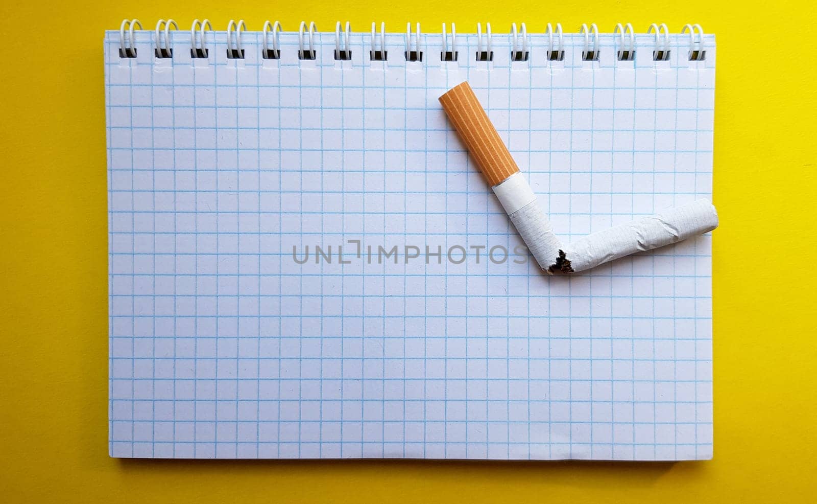 World No Tobacco Day, No Smoking Day. Broken cigarette on a business notebook, place for your text.