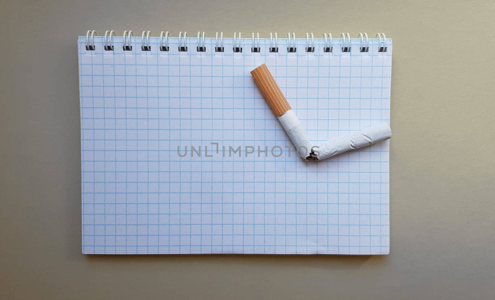 World No Tobacco Day, No Smoking Day. Broken cigarette on a business notebook, place for your text.