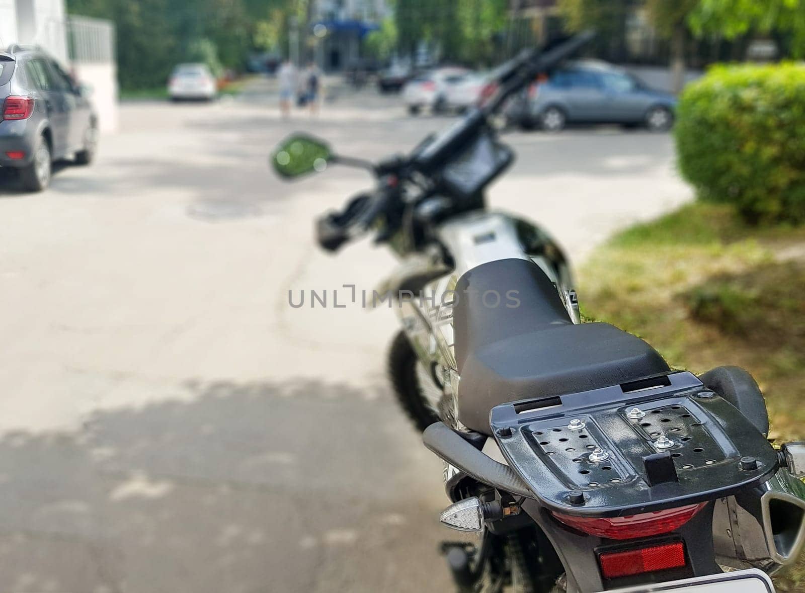 Black motorcycle parked. Back view. Soft focus.