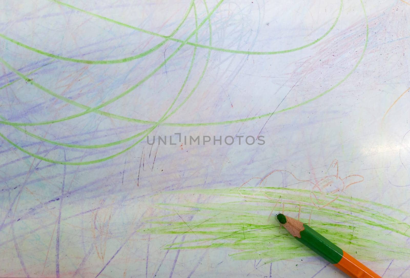 color pencils with drawn colored lines isolated on white background. Top view. Hand drawn scribble smears on paper.