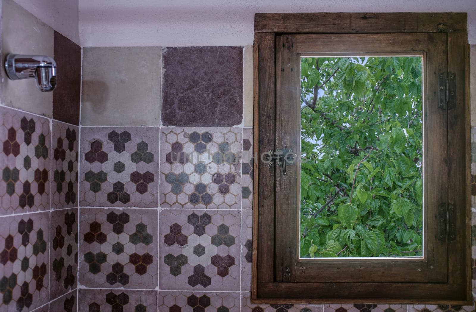Vintage rural hotel bathroom covered with old cement tiles..Rural tourism concept