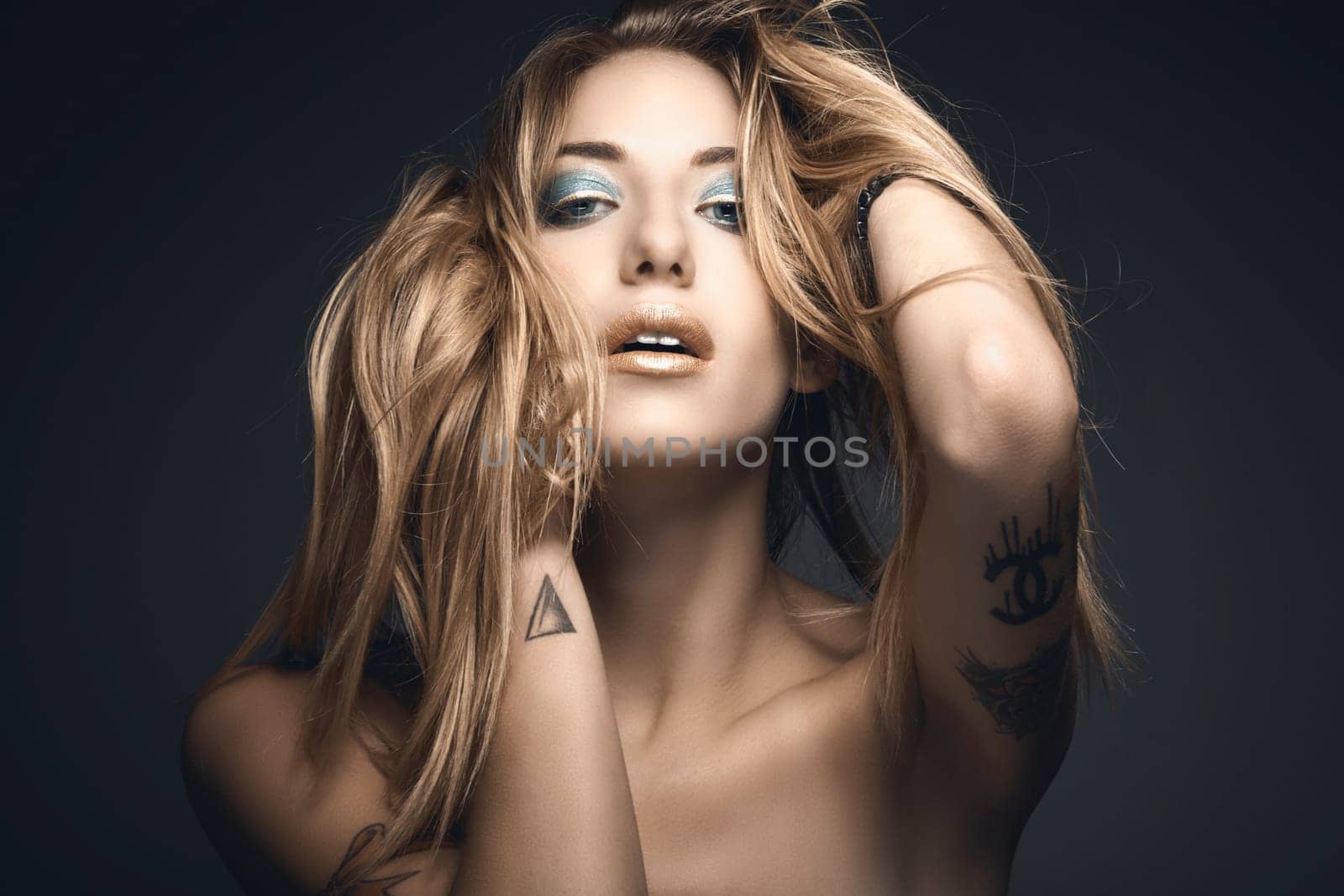 Beauty portrait of young sexy woman against blue background