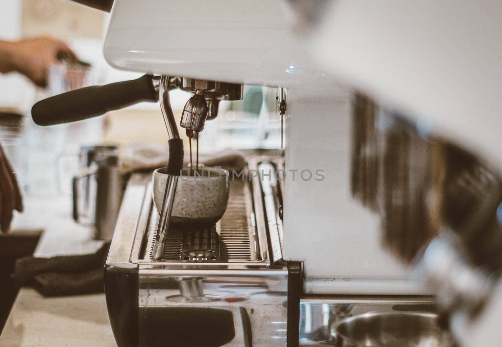 Close-up of coffee maker machine making cup of coffee in restaurant or coffee shop. Lifestyles of modern life in city. Business food and drink concept idea