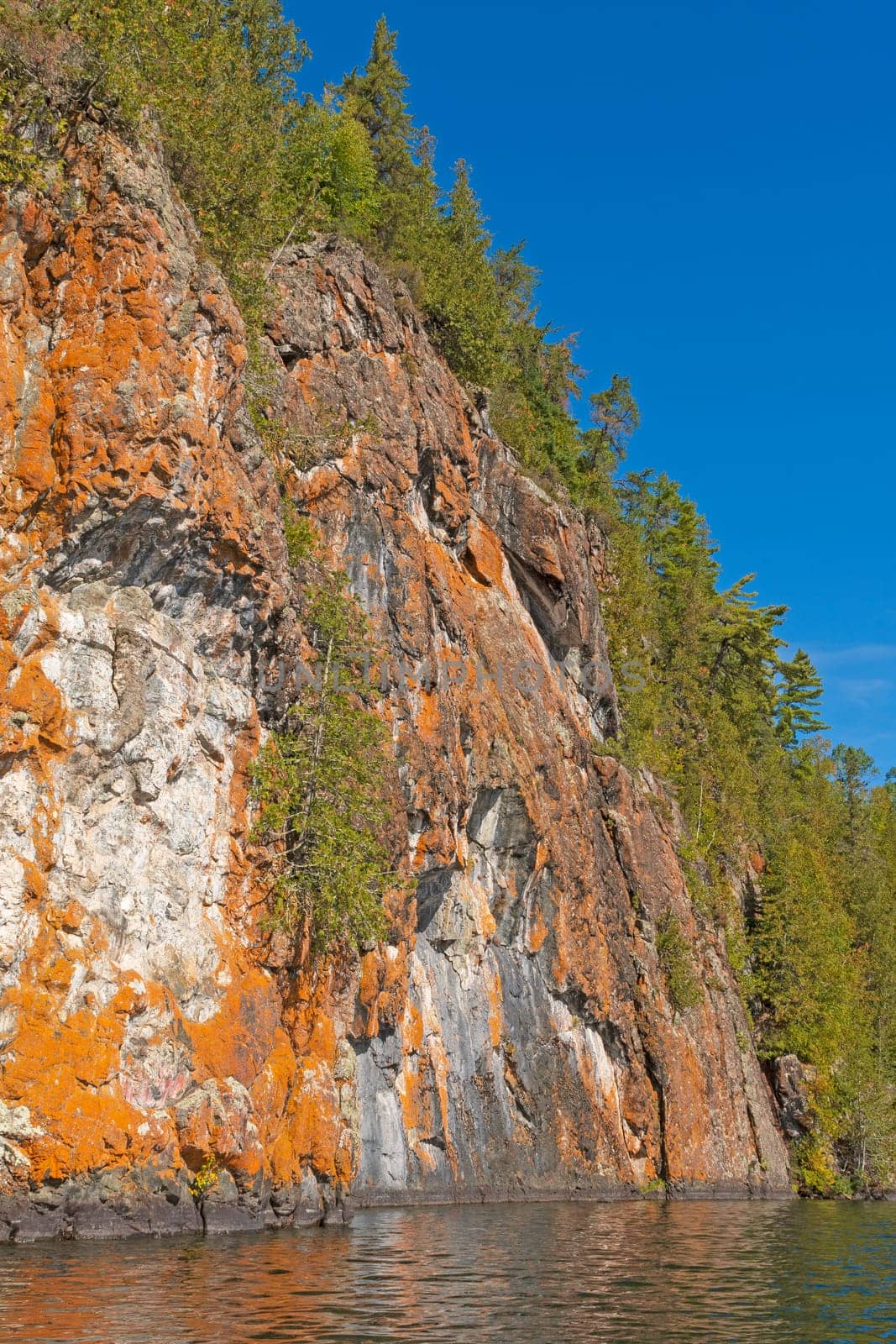 Orange Colored Cliffs High Above the Wilderness Waters on Ottertrack Lake in the Boundary Waters in Minnesota
