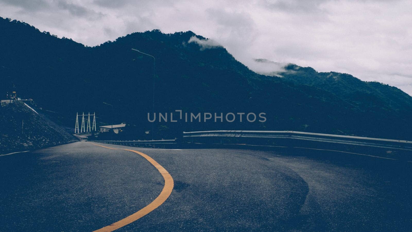 Asphalt road with yellow line curve. Black and yellow asphalt road, Road curve, Road Background, angle, highway, material. Curved Road With Yellow Line.