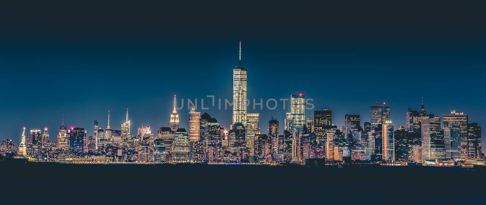 New York City Manhattan downtown skyline at dusk with skyscrapers illuminated over Hudson River panorama. Vertical composition.