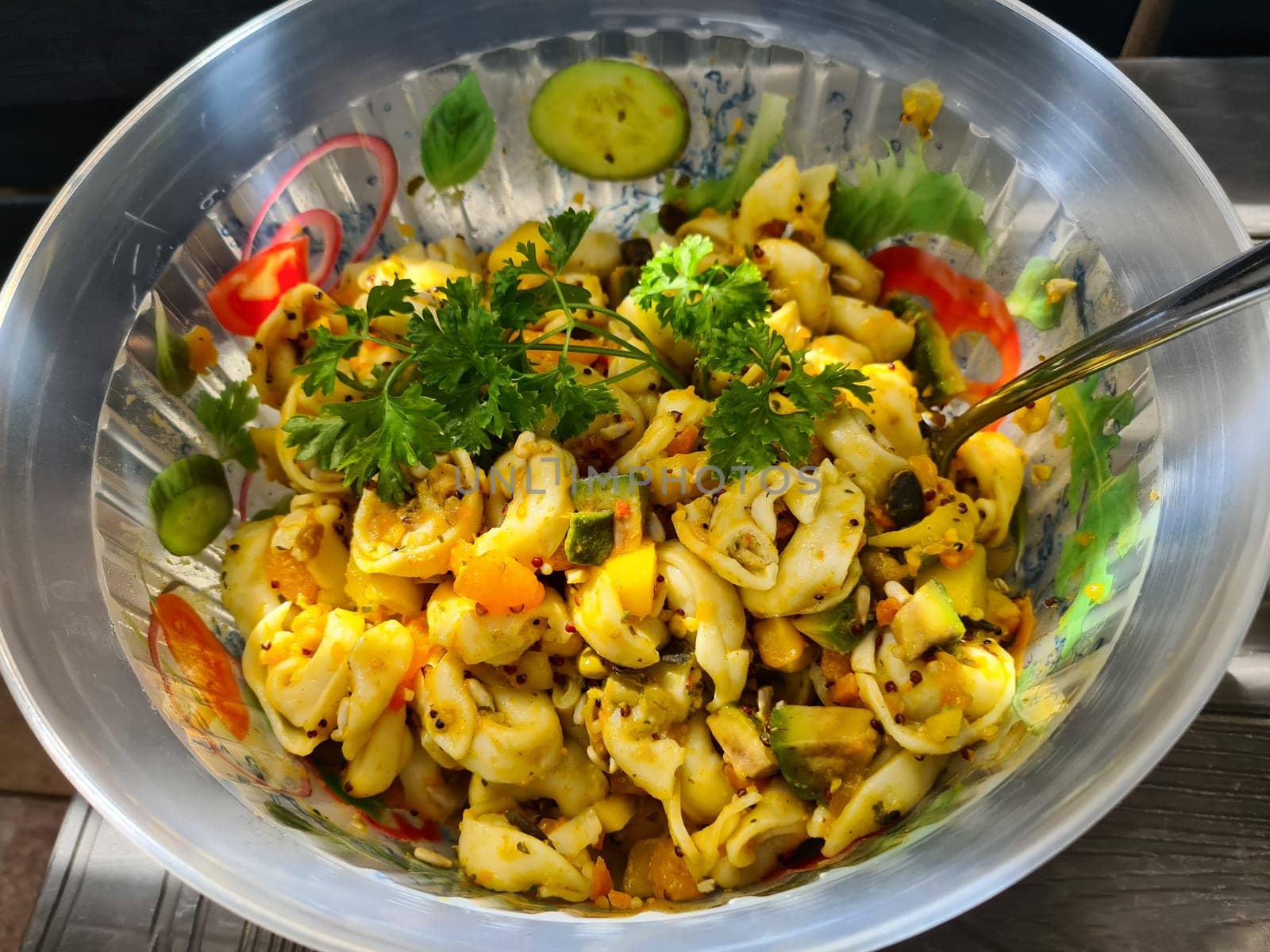 Bowl of fusili pasta salad with fresh vegetables
