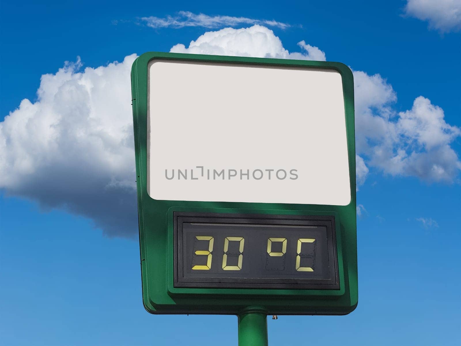 Electronic large thermometer on the building, indicating a high summer air temperature 30 degrees Celsius. Summer hot weather, heat