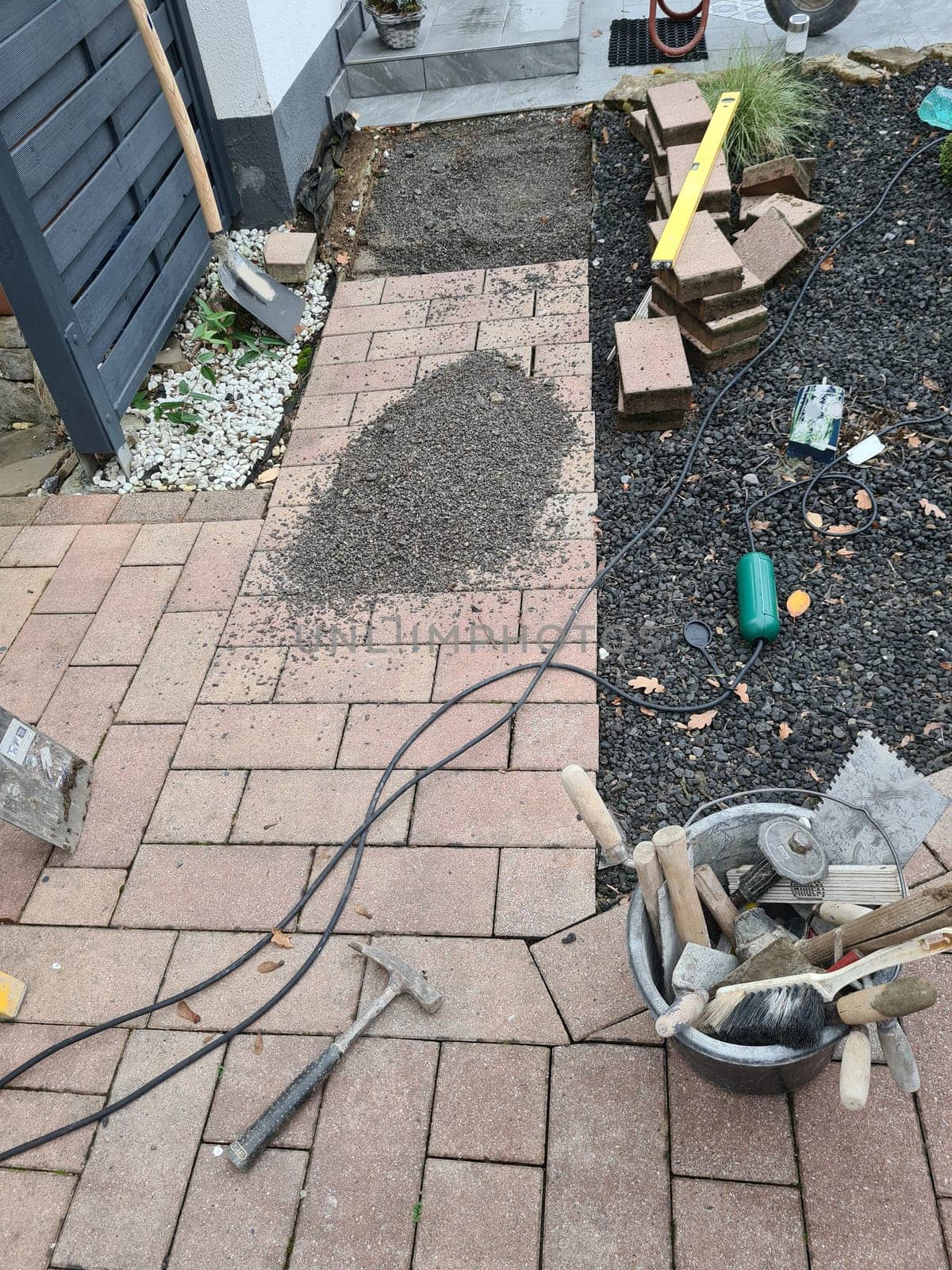 Worker laying pavement rocks