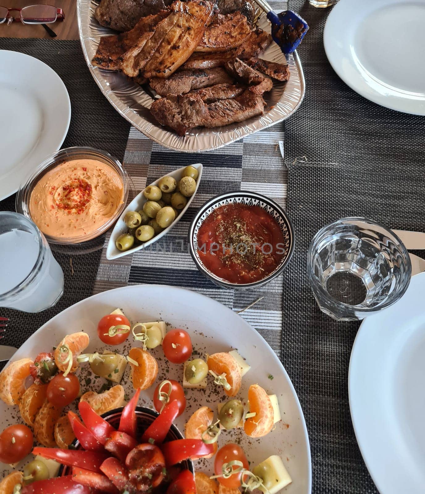 Cheese plate served with Grilled meat and vegetables on rustic wooden table