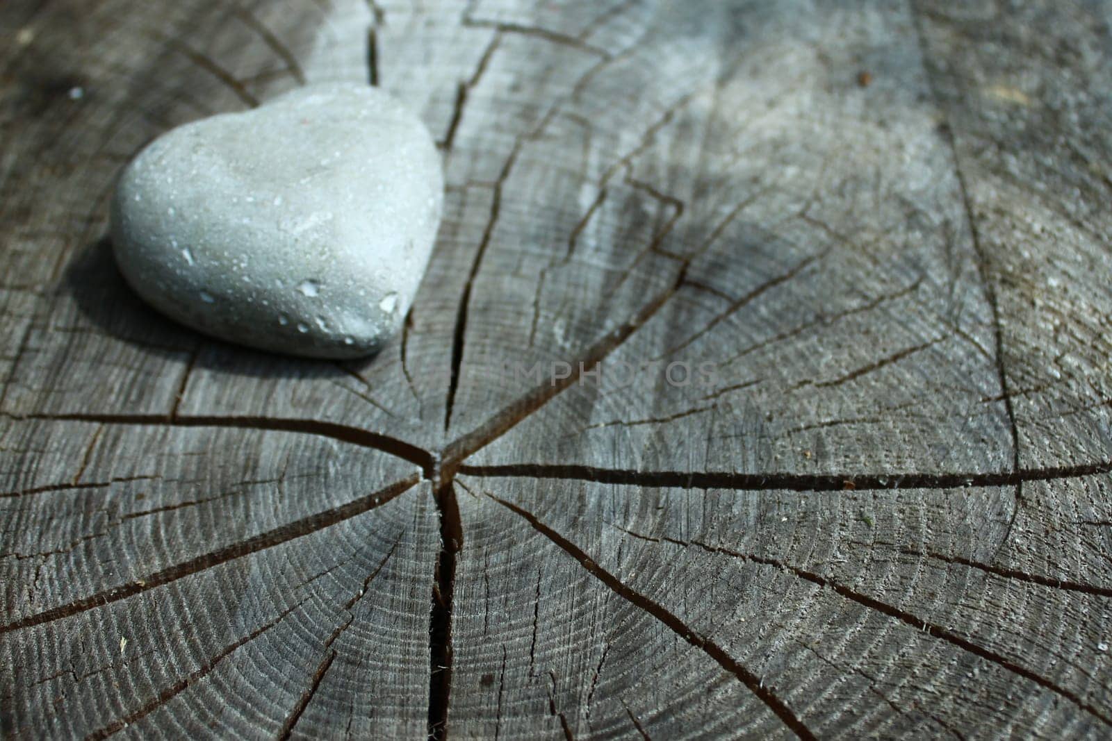 a heart of stone on wooden ground