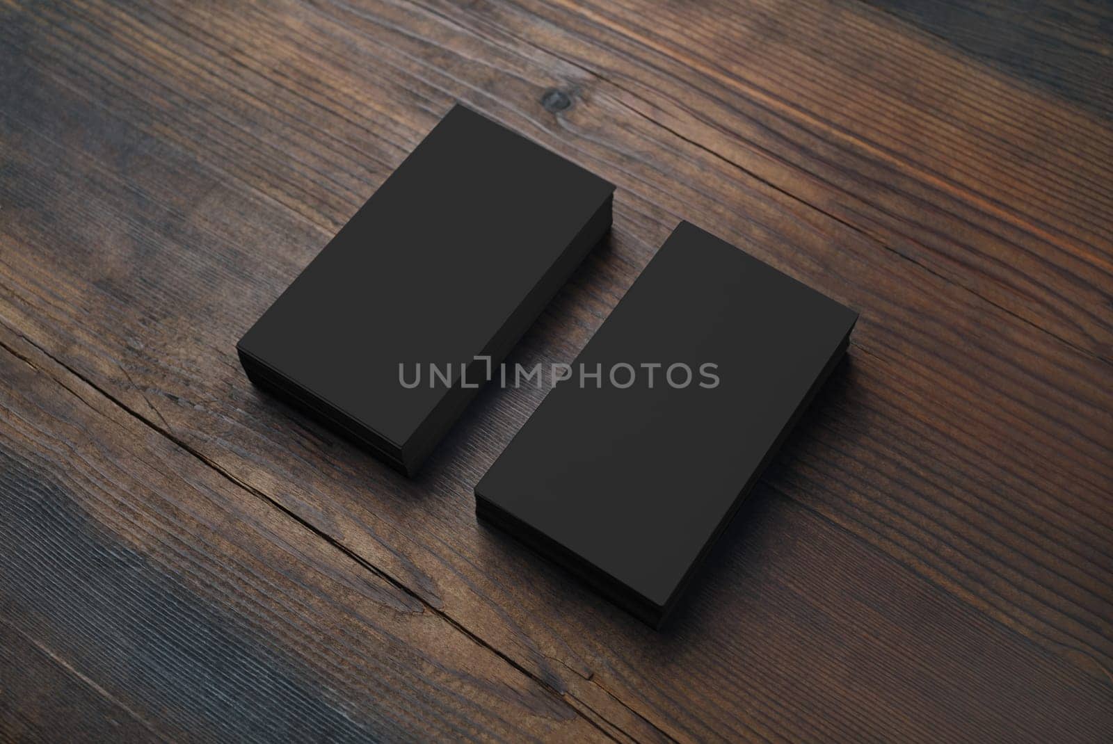 Photo of blank black business cards on wooden background. Template for branding identity.