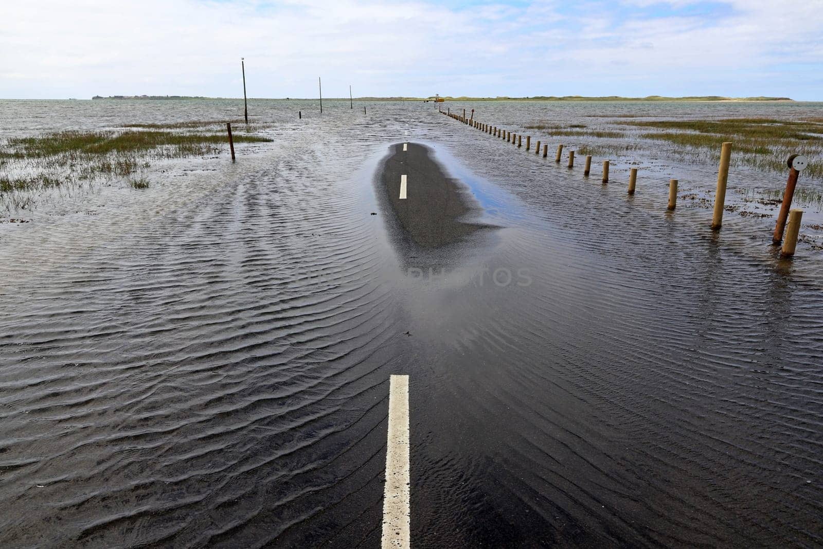 High water has completely flooded a road. Dangerous storm with a lot of rain