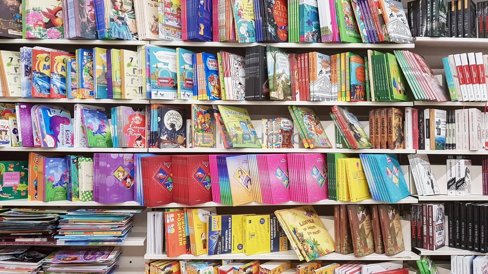 Ukraine, Kiev - October 10, 2019: a store of children's and adult literature. Showcases on the market with new books. Editorial photo