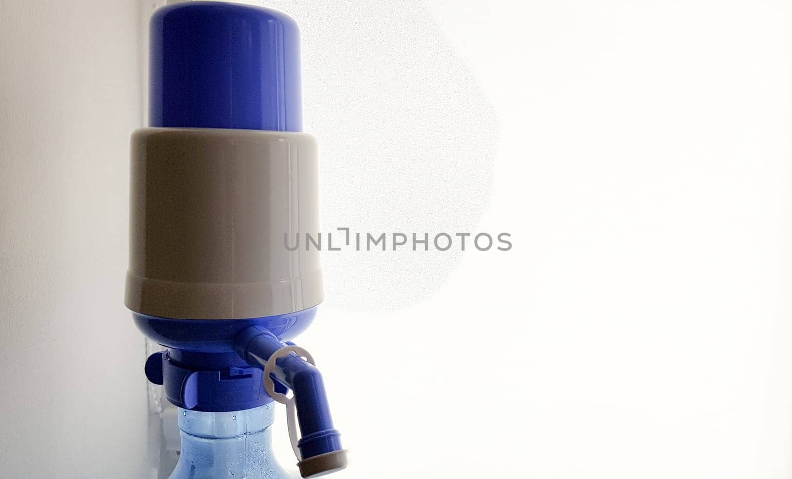 pump on a water bottle. Close-up on a white background.