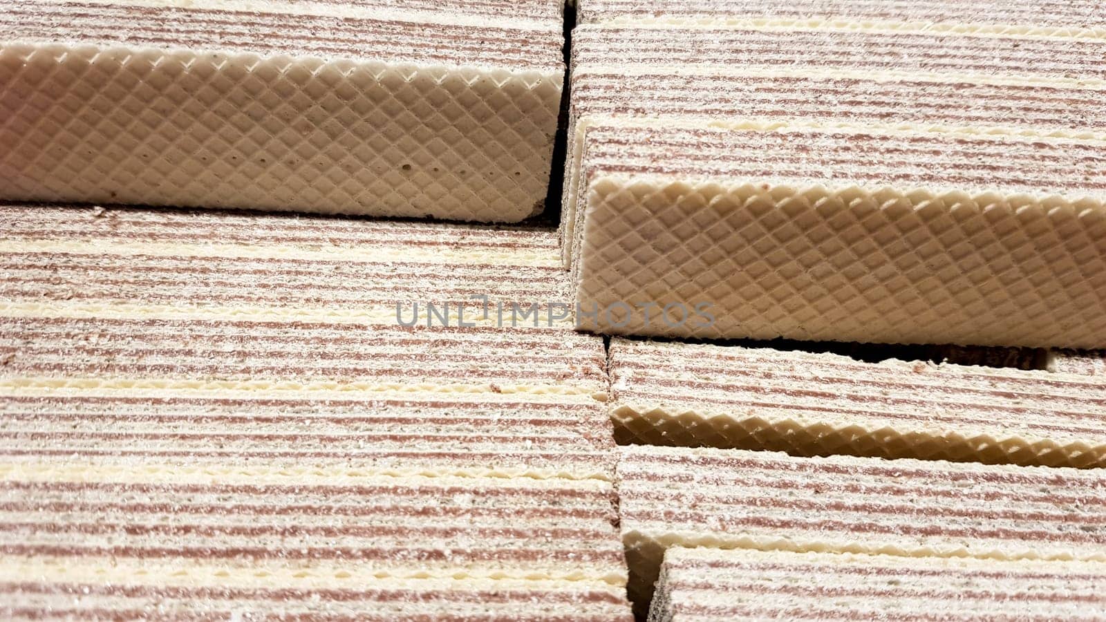 Close-up of yellow and brown waffles stuffed to a box.