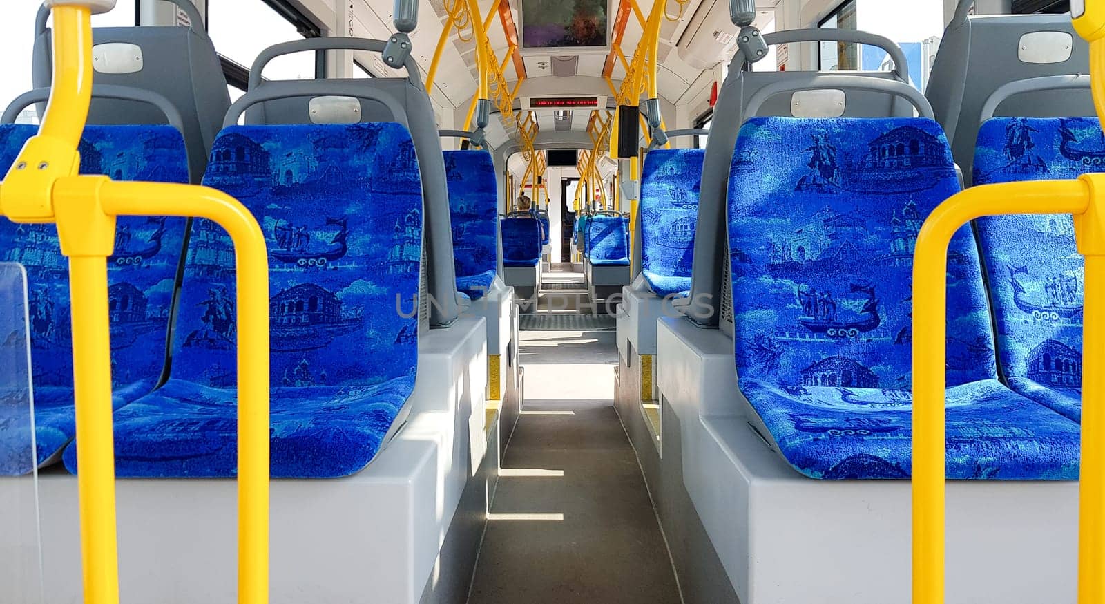 Ukraine, Kiev - September 08, 2019: Empty city tram salon. Public ground transportation within the city. Seats for passengers. Handrails for carrying out. Contactless payments of transport validators. Passenger city transport.