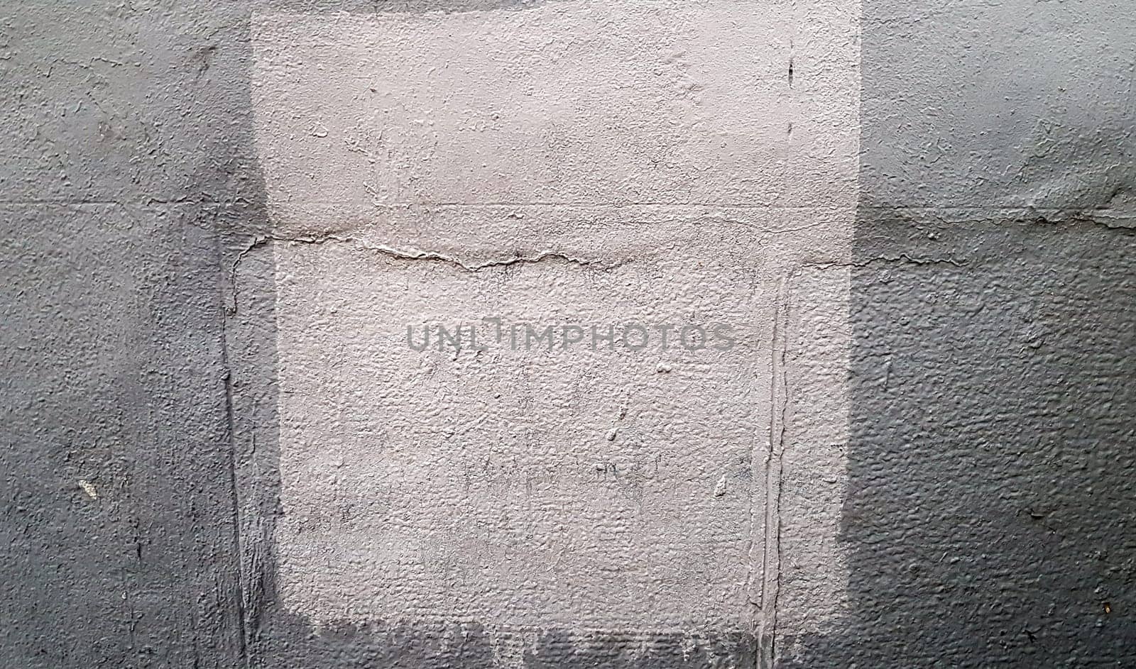 Gray concrete wall. Large coarse strokes of paint on the surface of the house. Close-up. Classic background. Copy space. Place for text