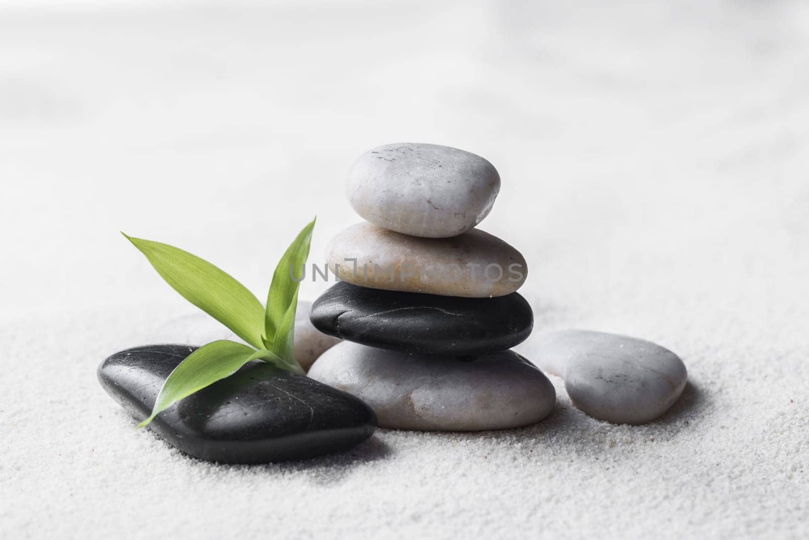 zen basalt stones and bamboo on the sand