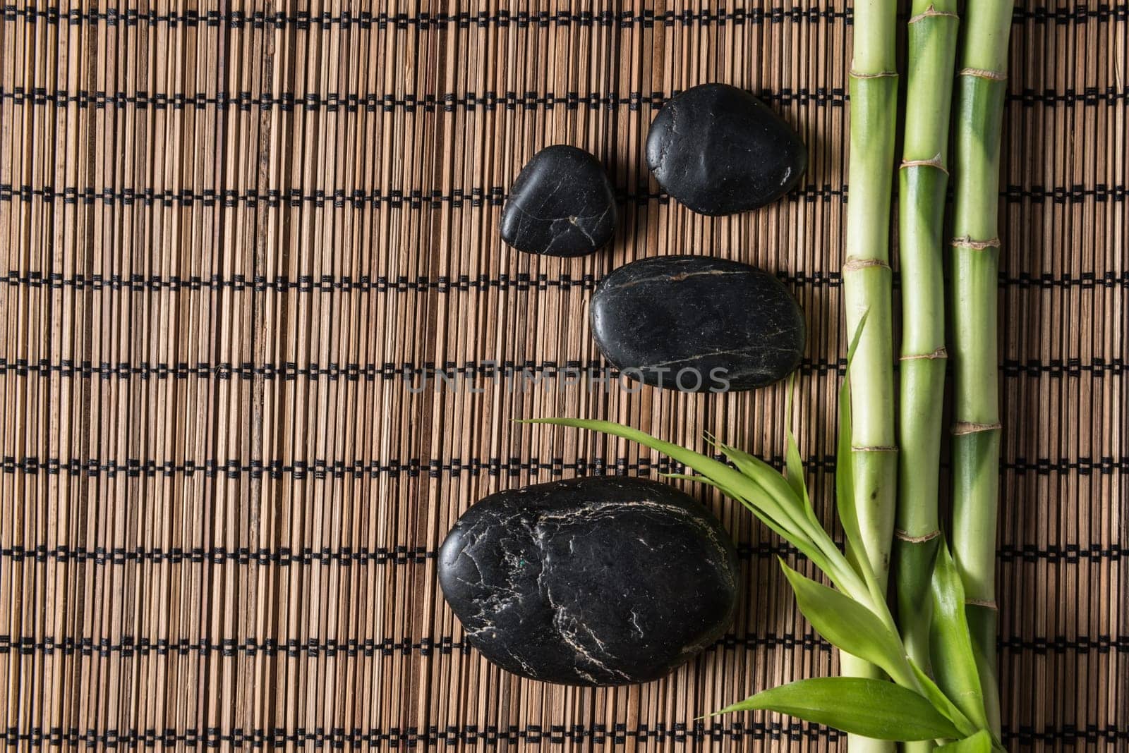 zen basalt stones and bamboo on the mat