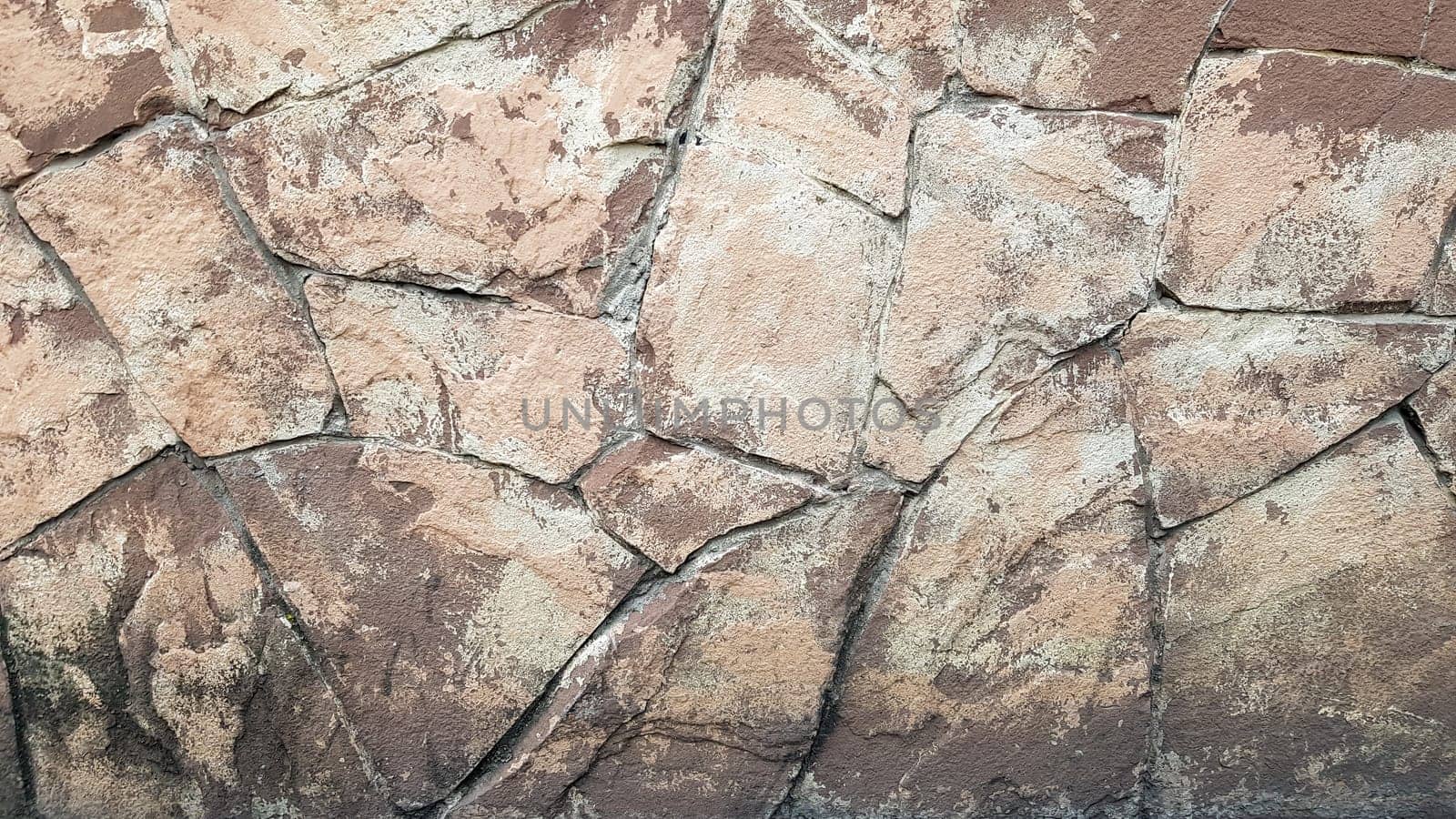 Gray stone wall background. The texture of the stone. Old castle wall background. Stone wall as a background or texture. Part of the wall, for background or texture