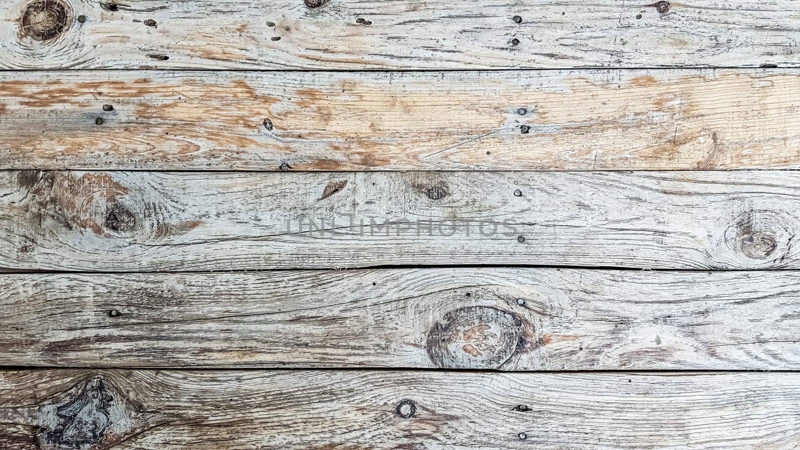 Grunge plank wood texture background. Close up of gray wooden fence panels.