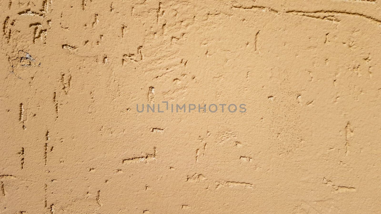 Old gold plaster wall texture yellow background. Textured textured wall plaster. Embossed wall decoration. Stucco walls. Embossed wall decoration. Decorative plaster is painted yellow