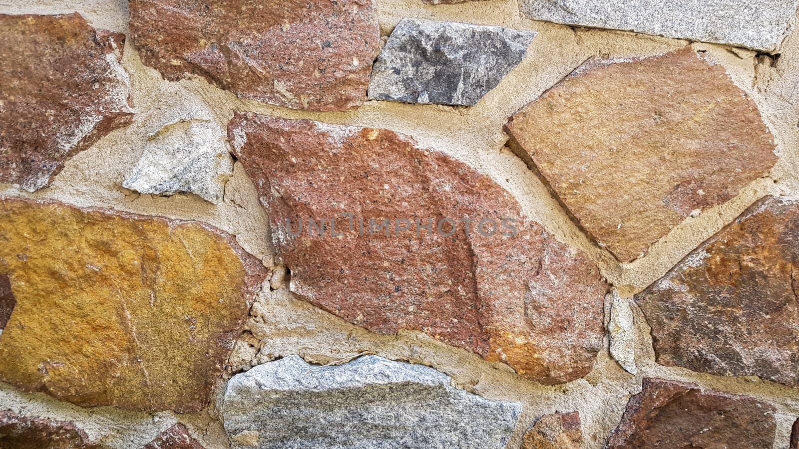 Gray stone wall background. The texture of the stone. Old castle wall background. Stone wall as a background or texture. Part of the wall, for background or texture